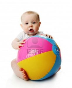 9939533-adorable-baby-playing-with-a-colorful-beach-ball-isolated-on-white